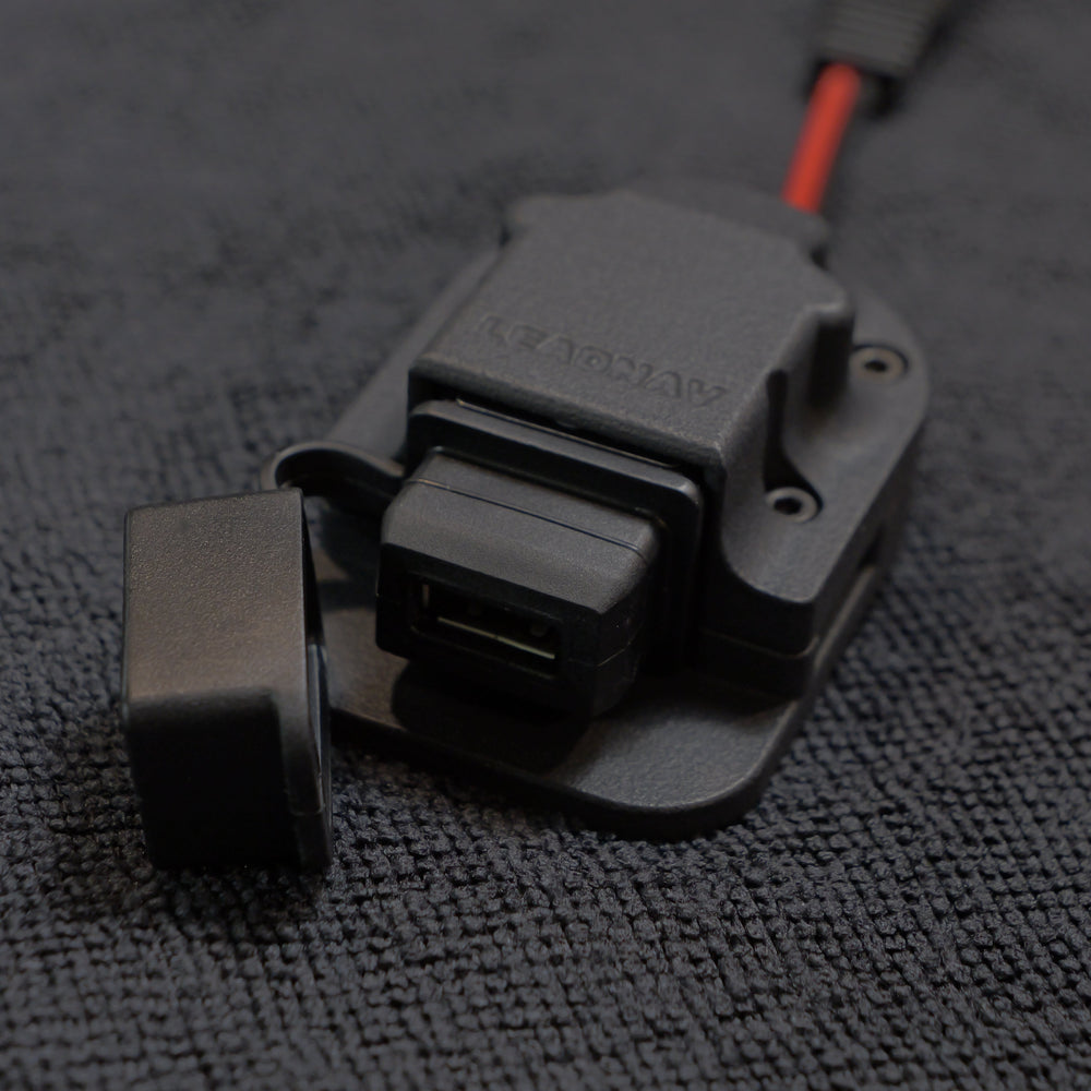 Close-up of a black and gray electronic component on a textured gray surface