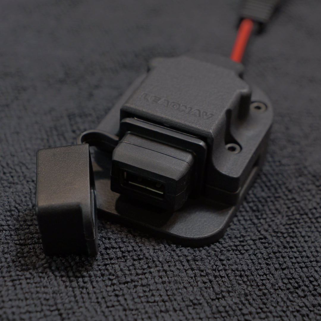 Close-up of a black and gray electronic component on a textured gray surface