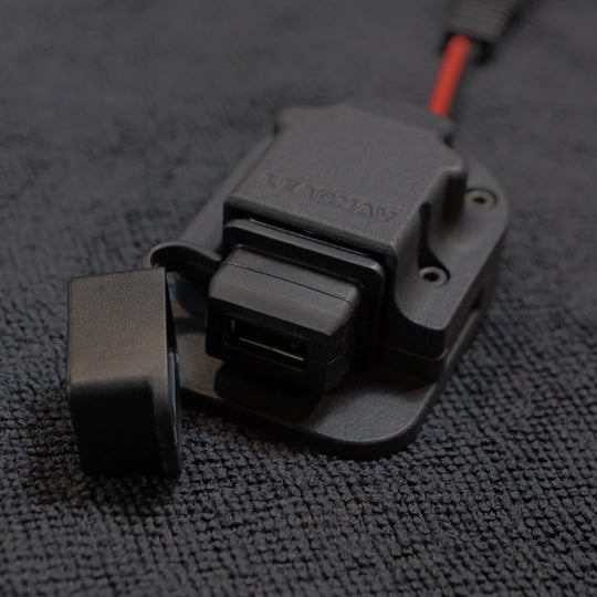 Close-up of a black and gray electronic component on a textured gray surface